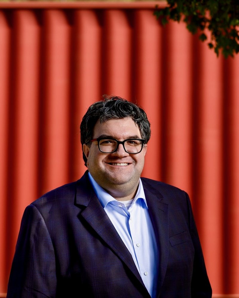 Chuck Giroux, standing in front of a shipping container.